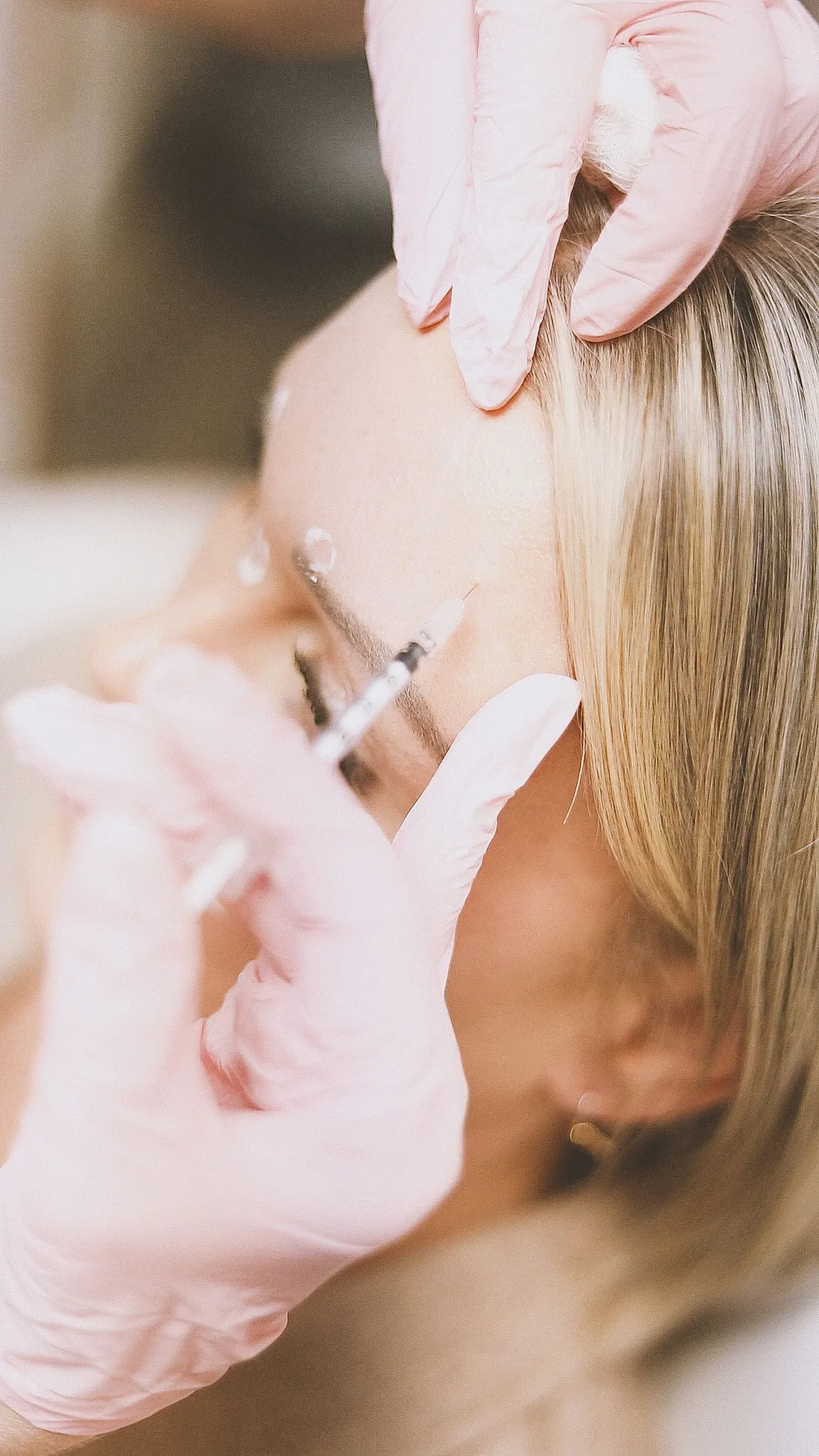 A doctor administering anti-wrinkle injections