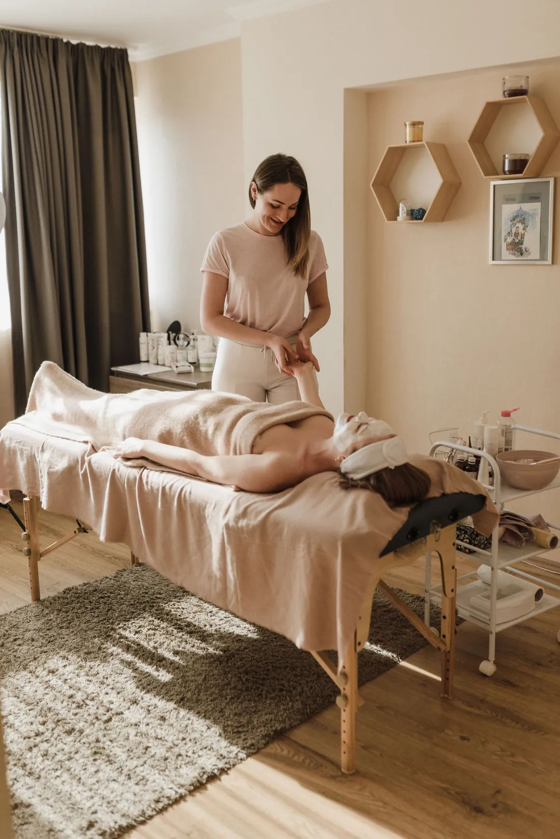 A therapist preparing a client for a treatment in a calm, sunlit therapy room